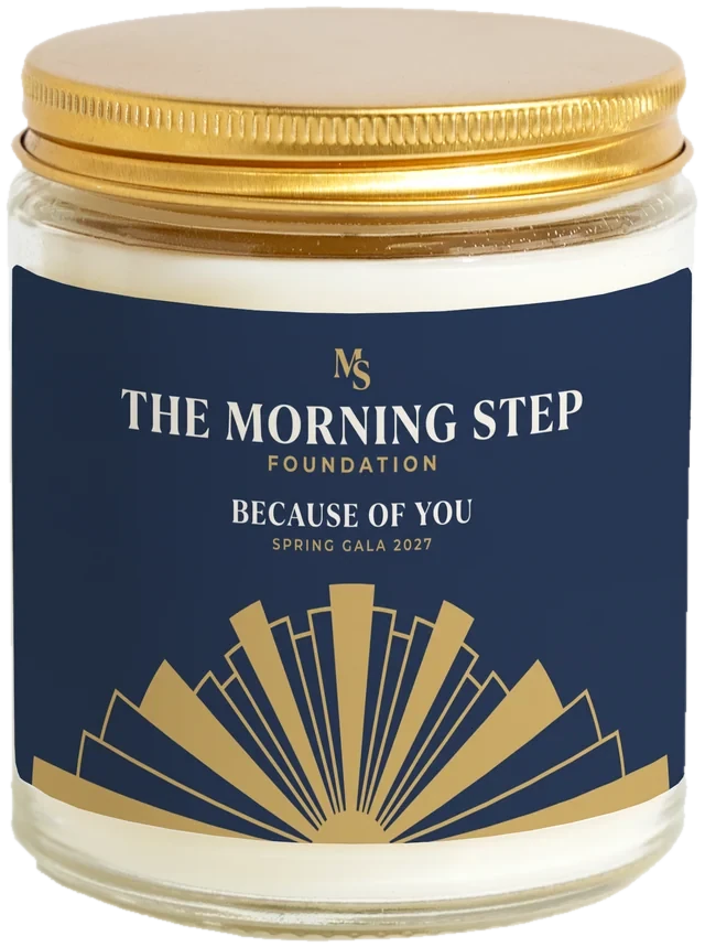 A 9 oz candle jar with a sample Alumni & donor gifts label