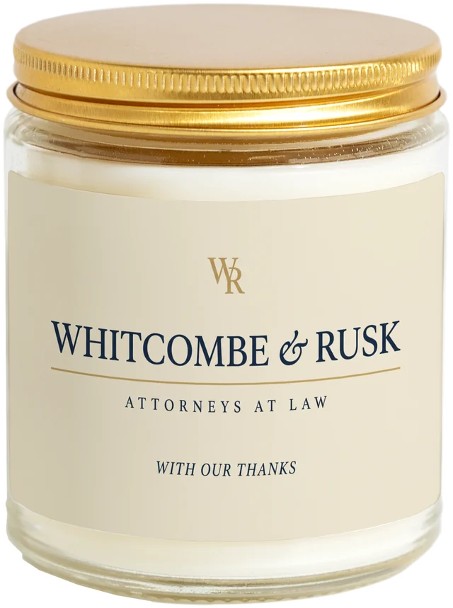 A 9 oz candle jar with a sample Law firm client gifts label