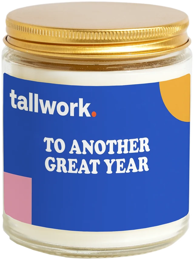 A 9 oz candle jar with a sample Marketing agency client gifts label