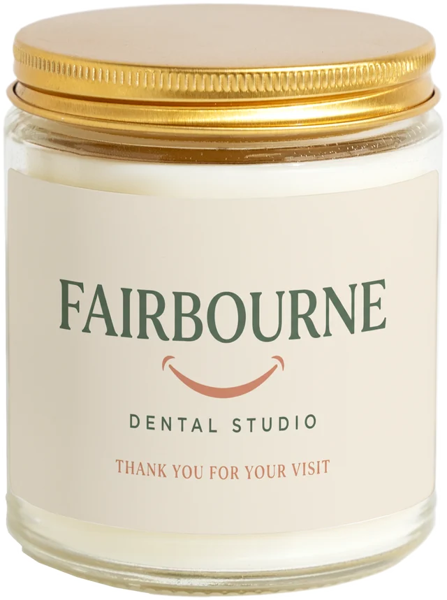 A 9 oz candle jar with a sample New patient welcome gifts label