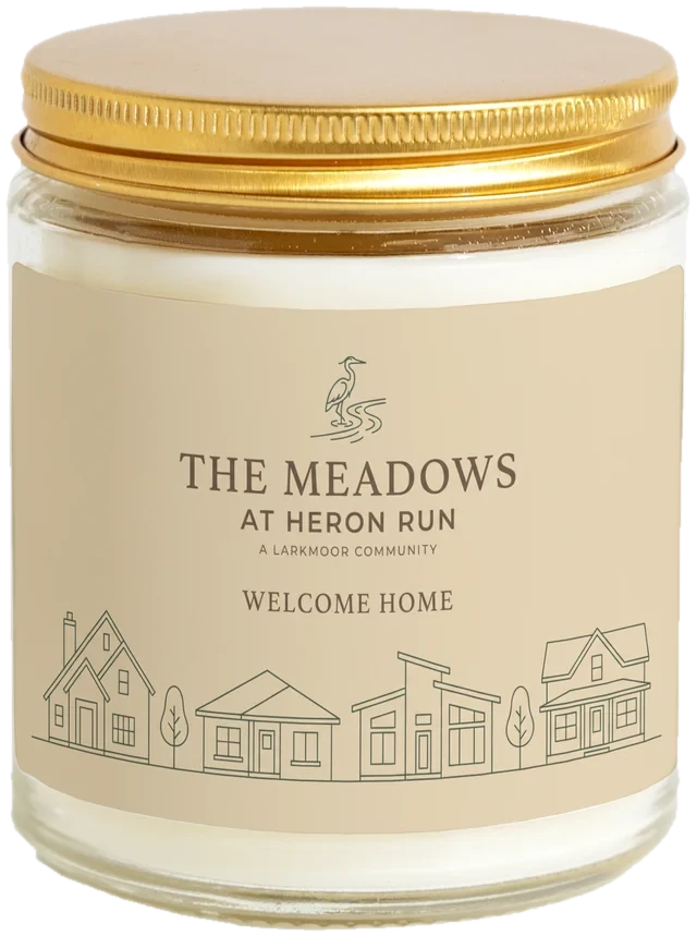 A 9 oz candle jar with a sample Home builder closing gifts label