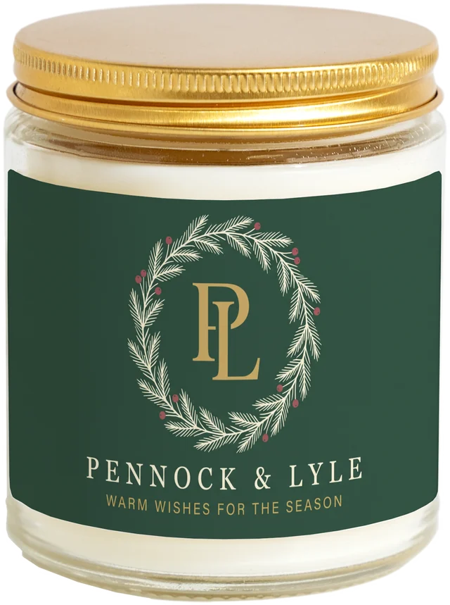 A 9 oz candle jar with a sample Christmas client gifts label