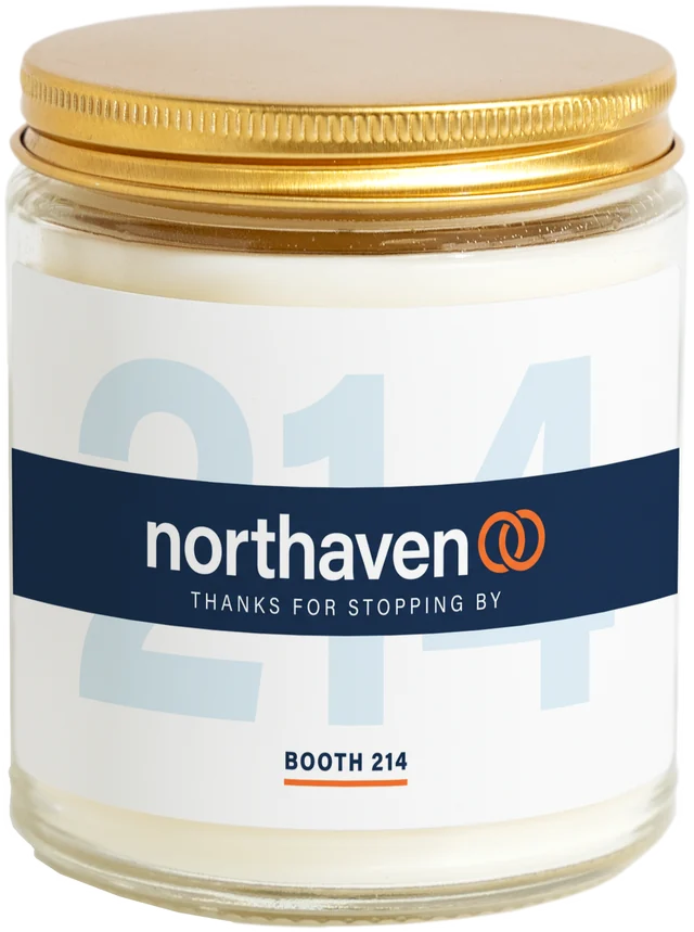A 9 oz candle jar with a sample Conference & trade show gifts label