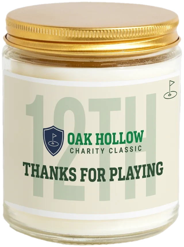 A 9 oz candle jar with a sample Golf tournament gifts label