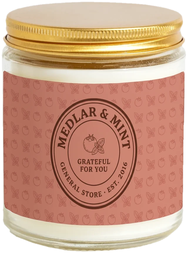 A 9 oz candle jar with a sample Customer appreciation day gifts label