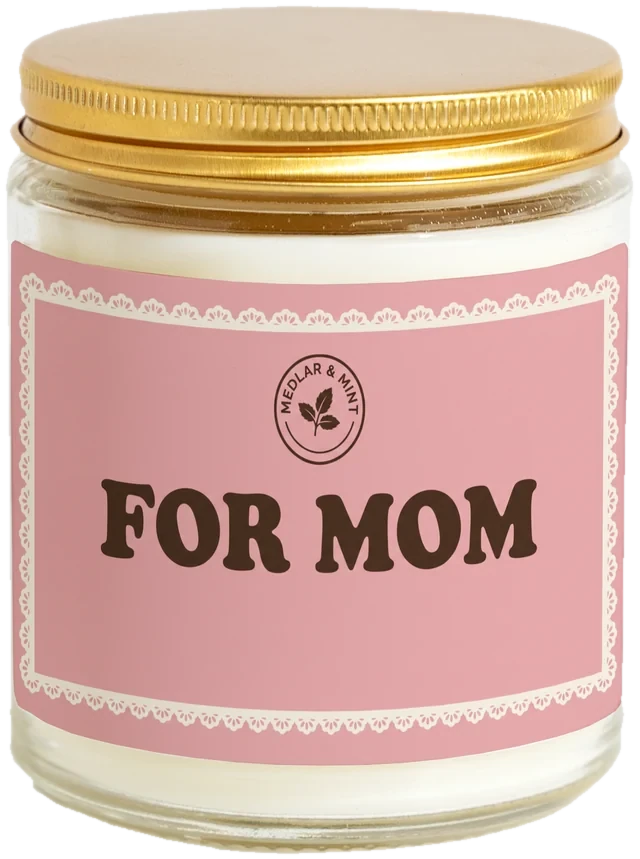 A 9 oz candle jar with a sample Mother's Day gifts in bulk label