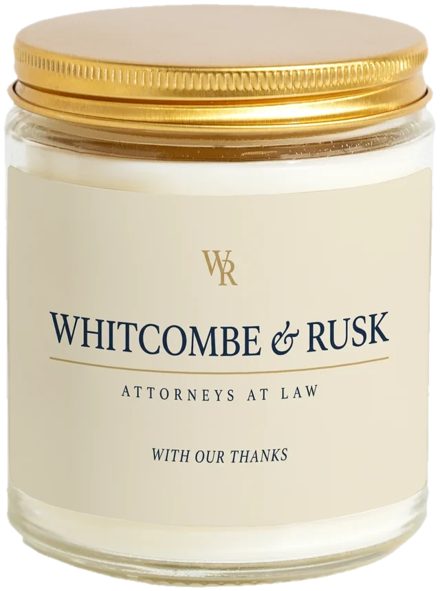 A 9 oz candle jar with a sample Law firm client gifts label