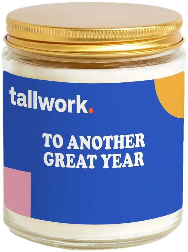 A 9 oz candle jar with a sample Marketing agency client gifts label