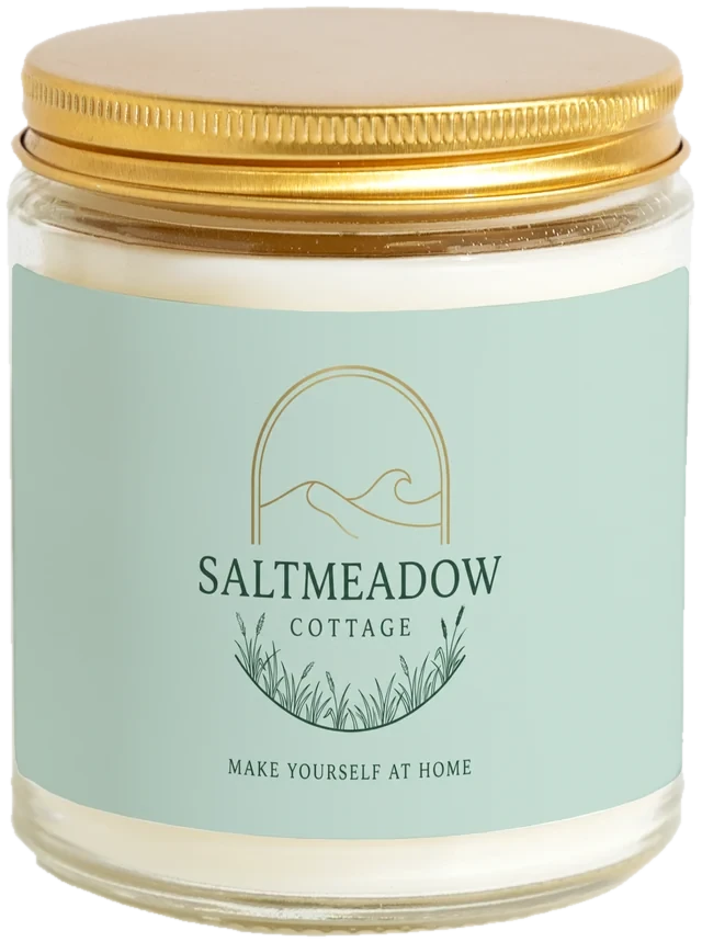 A 9 oz candle jar with a sample Short-term rental welcome gifts label