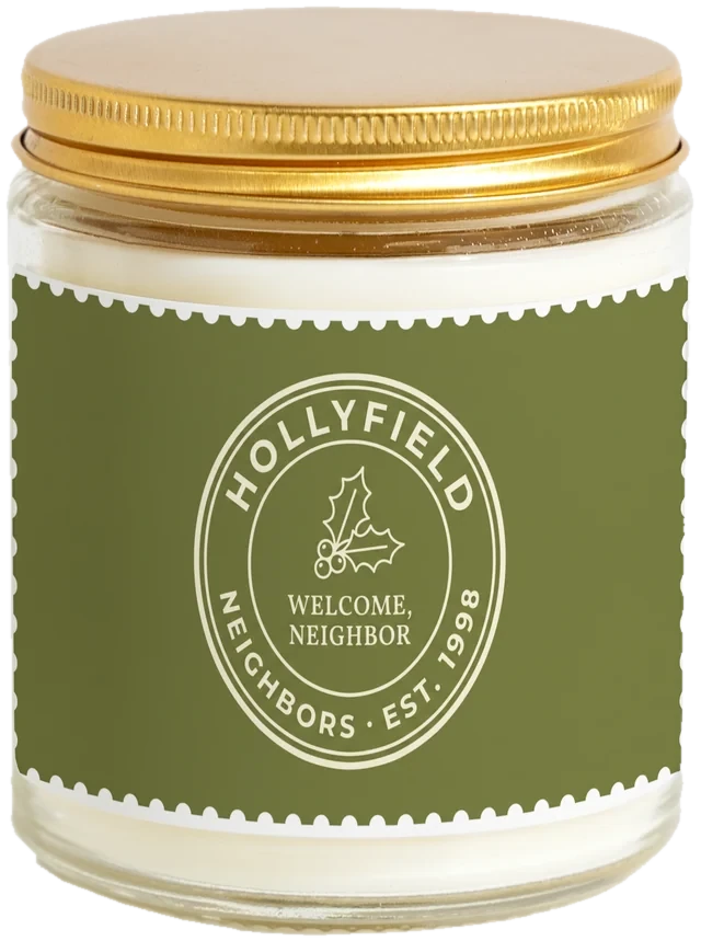 A 9 oz candle jar with a sample HOA & community gifts label