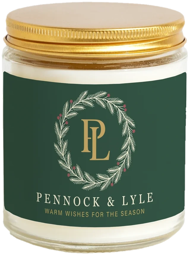 A 9 oz candle jar with a sample Christmas client gifts label