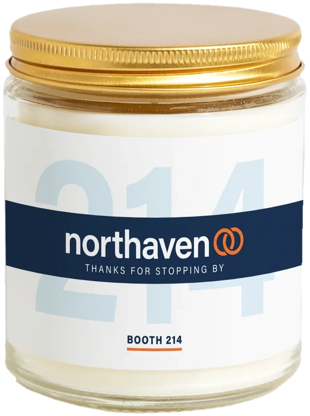 A 9 oz candle jar with a sample Conference & trade show gifts label